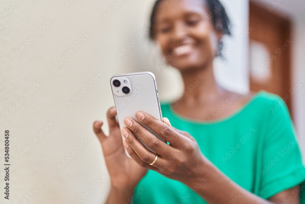 Middle age african american woman smiling confident using smartphone at street Middle age african american woman smiling confident using smartphone at street