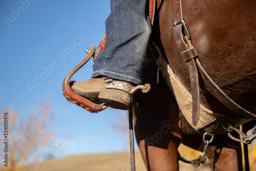 Western boot and spur in a stirrup. photo