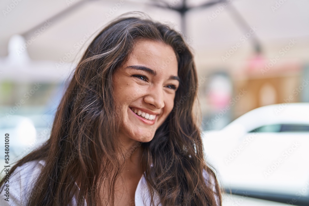 Young hispanic woman smiling confident looking to the side at street Young hispanic woman smiling confident looking to the side at street