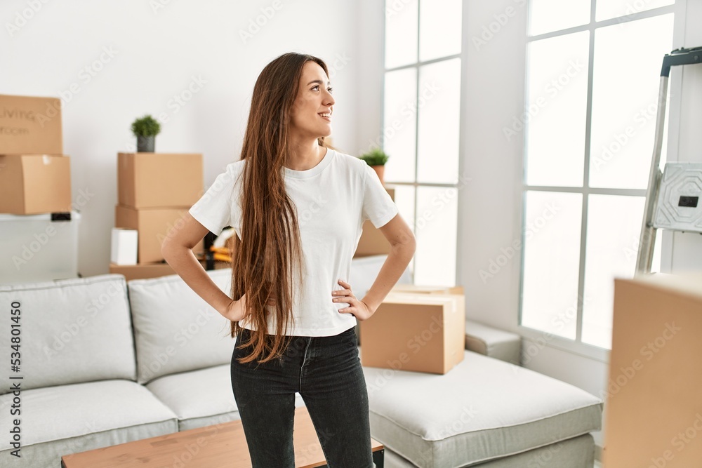 Young hispanic woman smiling confident standing at new home Young hispanic woman smiling confident standing at new home