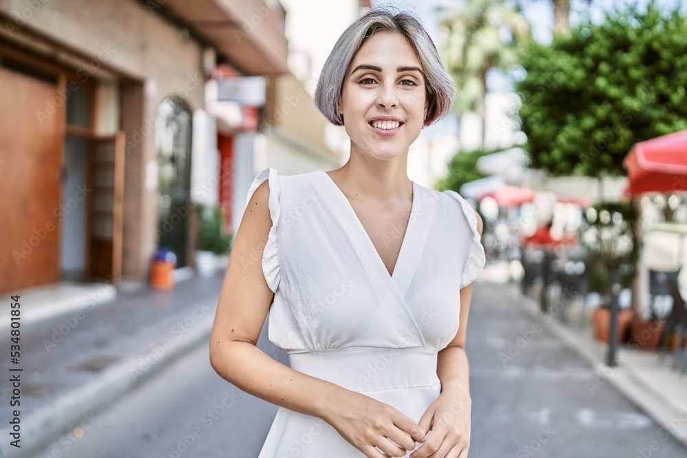 Young caucasian girl smiling happy standing at the city. Young caucasian girl smiling happy standing at the city.