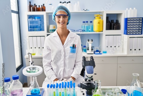 Brunette woman working at scientist laboratory with a happy and cool smile on face. lucky person.
