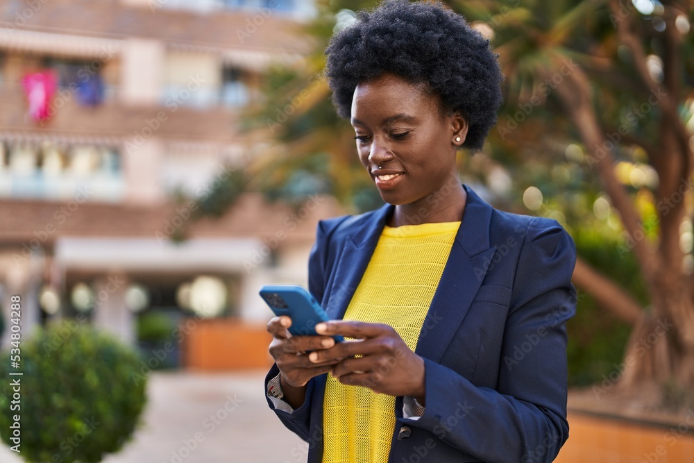 Young african american woman business executive using smartphone at park Young african american woman business executive using smartphone at park