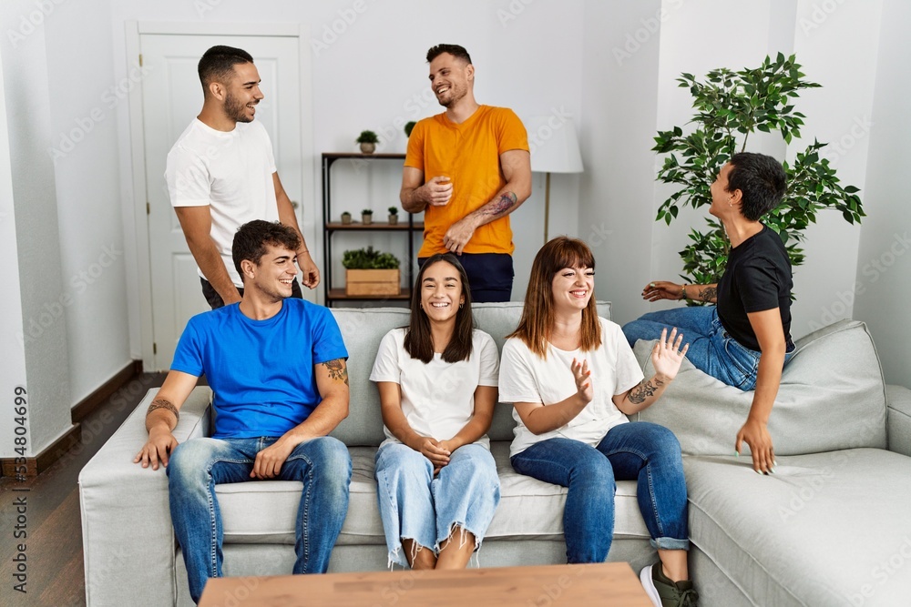 Group of young friends smiling happy sitting on the sofa at home. Group of young friends smiling happy sitting on the sofa at home.