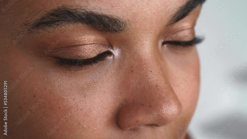 Close-up of the face of a young beautiful multi-ethnic woman. Partial view of a beautiful pensive female face looking thoughtfully into the distance. Emotional portrait. Close-up of the face of a young beautiful multi-ethnic woman. Partial view of a beautiful pensive female face looking thoughtfully into the distance. Emotional portrait.