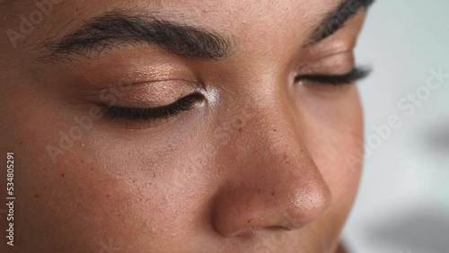 Close-up of the face of a young beautiful multi-ethnic woman. Partial view of a beautiful pensive female face looking thoughtfully into the distance. Emotional portrait. photo