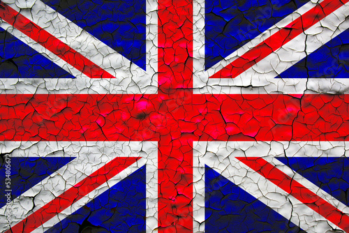 United Kingdom flag painted over cracked concrete wall. economic crisis in United Kingdom concept.