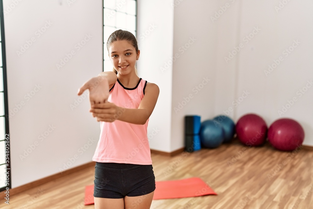 Adorable girl smiling confident stretching at sport center Adorable girl smiling confident stretching at sport center