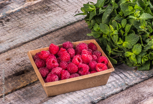 Obraz na płótnie Eco-friendly box with raspberries. Frozen raspberry preparation w salonie