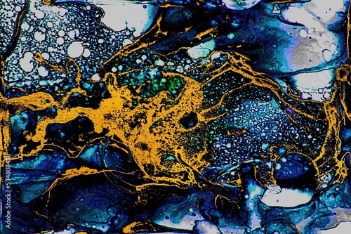 Deep blue ink and golden dust on Alcohol ink fluid abstract texture fluid art with gold glitter and liquid.