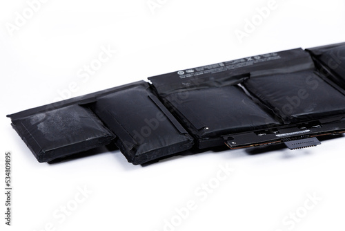 Swollen laptop battery on a white background