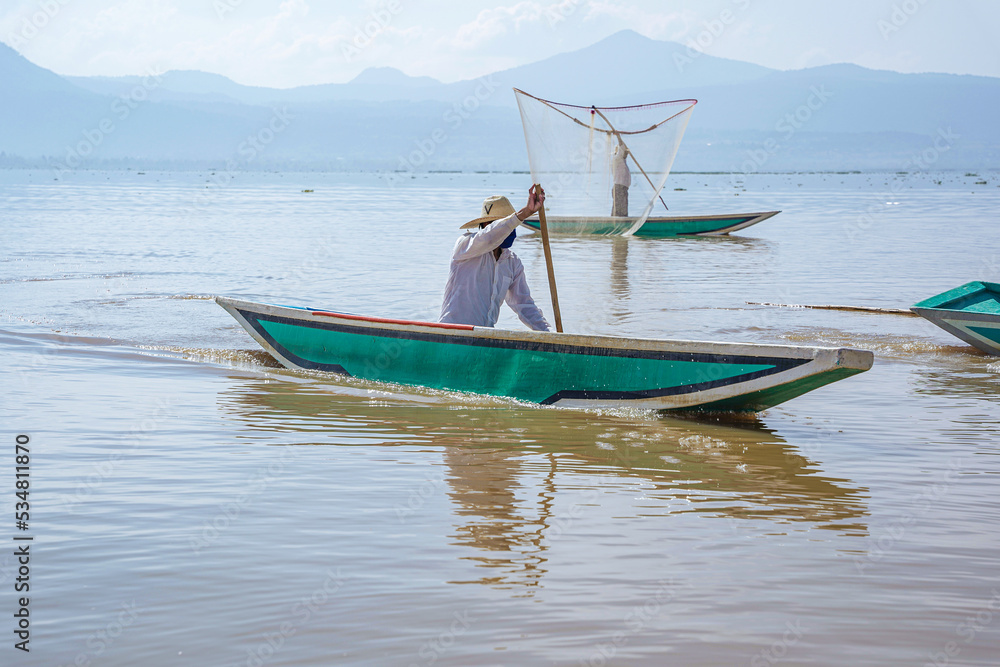 Naklejka premium Man fishing at the lake in the morning 