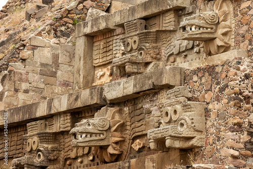 The walls of the pyramid are decorated with stone carvings. Teotihuacan, Mexico photo