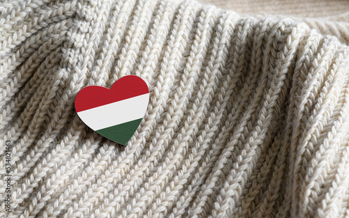 Photography Flag of the Hungary in the shape of a heart on warm woolen things