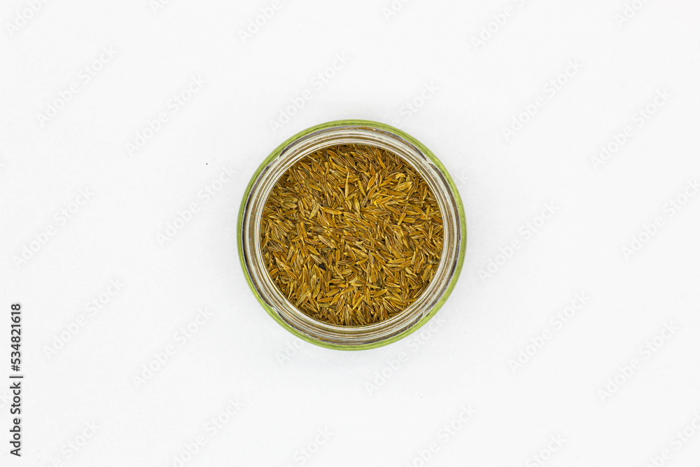 Spices Cumin Zira on a white background. Oriental seasoning for cooking rice and meat pilaf. Aromatic spicy spices for delicious dishes. Dried Whole seeds flowering plant of a fruit Cumin. Isolated Spices Cumin Zira on a white background. Oriental seasoning for cooking rice and meat pilaf. Aromatic spicy spices for delicious dishes. Dried Whole seeds flowering plant of a fruit Cumin. Isolated