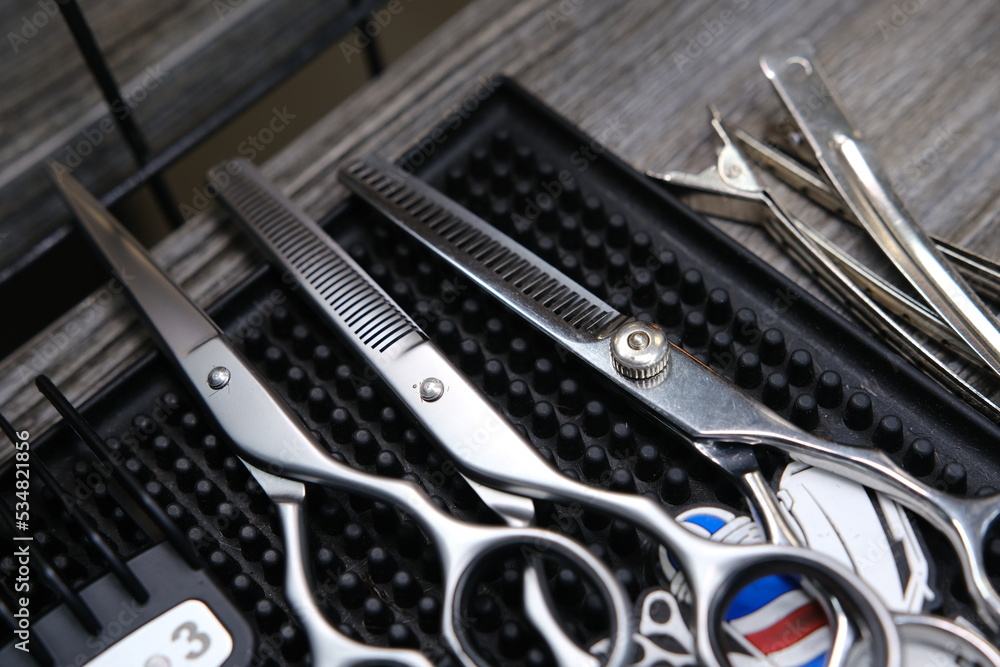 Fototapeta premium Vintage barber shop tools on old wooden background and rubber mat