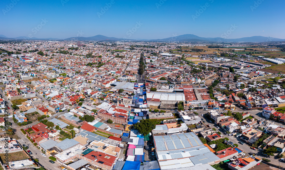 Aerial: panorama view of the mountains over the town. Drone view