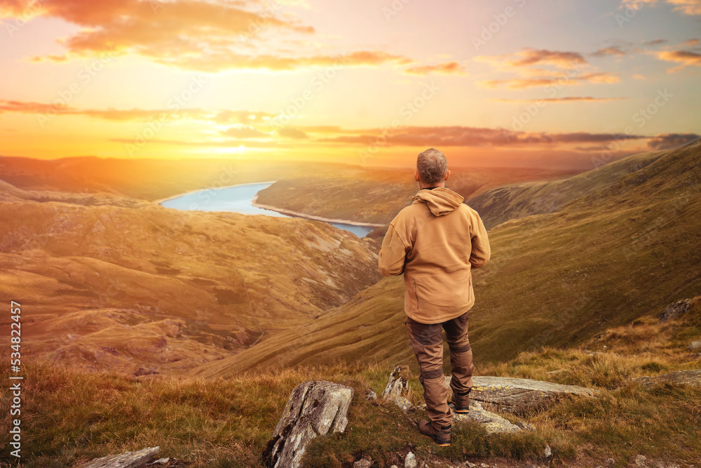 Bearded Man reaching the destination  and on the top of mountain  at sunset on autumn day  Travel  Lifestyle concept The national park Lake District in England