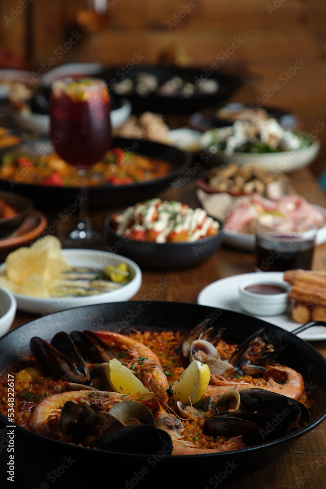 Spanish food served in a wooden table. Spanish food served in a wooden table.