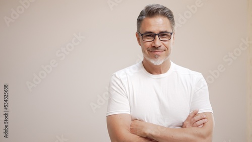 Portrait of happy casual older man smiling, Mid adult, mature age guy with gray hair in glasses, Isolated on white background, copy space. photo