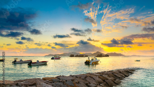View of the boat dock at sunset. Praslin Island is in the background. La Digue Island, Seychelles
