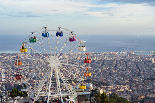 Ferris Wheel in Tibidabo Barcelona city from the top with city and sea on background 