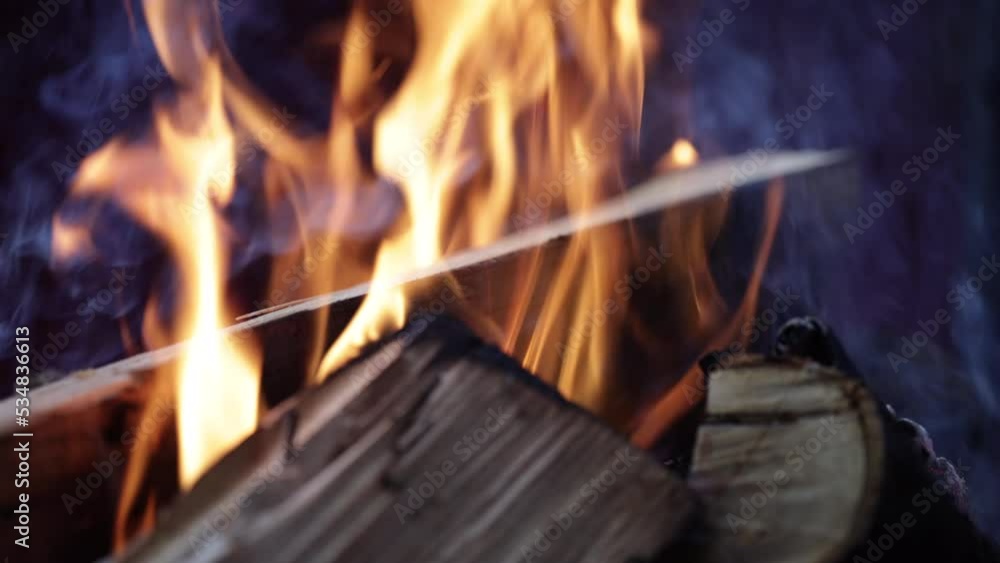 Firewood burning. Flame of fire from burning charcoal log. Selective Focus. 60 FPS, 4k, ProRes Firewood burning. Flame of fire from burning charcoal log. Selective Focus. 60 FPS, 4k, ProRes