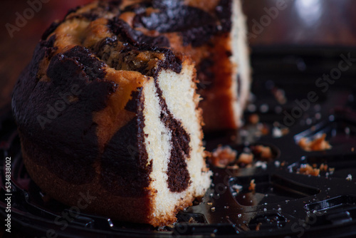 Marbled vanilla and chocolate cake on black tray photo