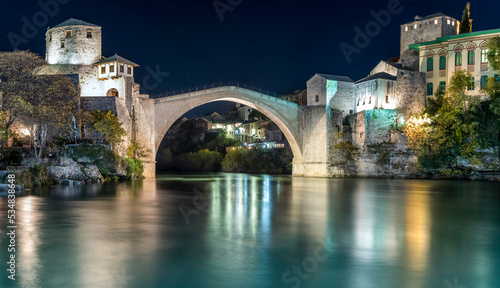 Stari most, mostar bridge famous touristic destination with night lights and reflection on water