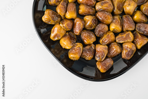Delicious Sukari dates ( kurma sukari ) Much sought after during the month of Ramadan as a dish to break the fast, ramadhan kareem, in white background, empty space, copy space