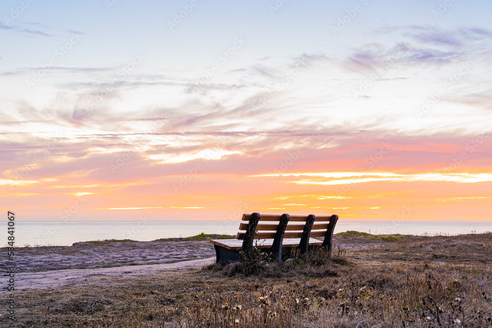Wooden bench at sunset