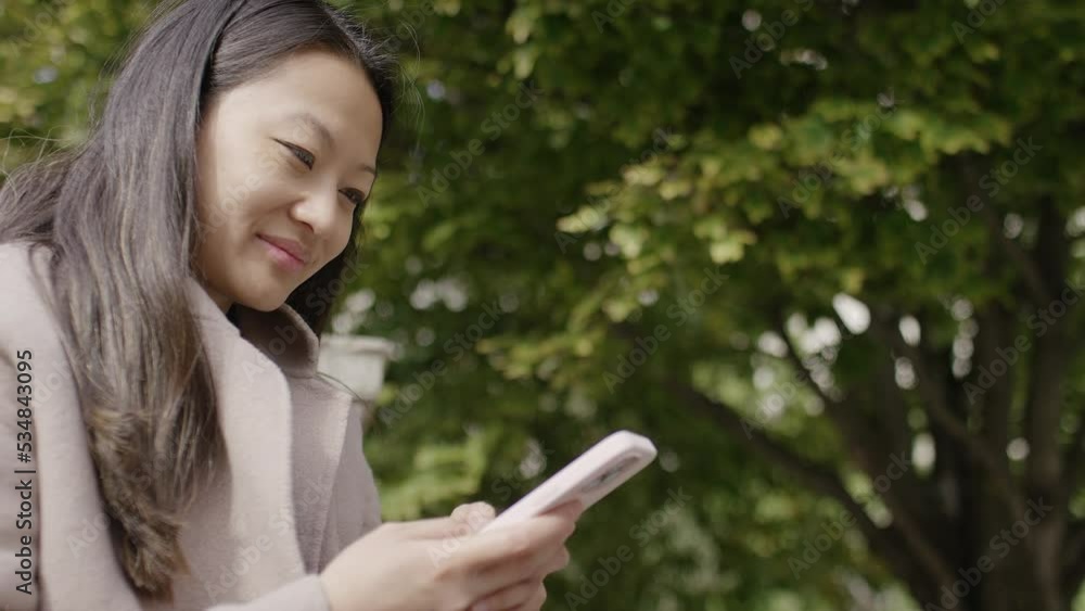 Portrait of young lady using her phone in the city, with space for text - in slow motion Portrait of young lady using her phone in the city, with space for text - in slow motion