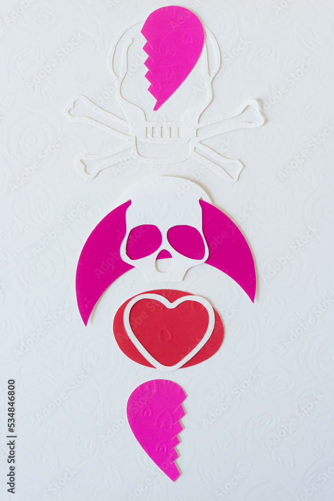 skull and crossbones, hearts, and heart halves on blank paper