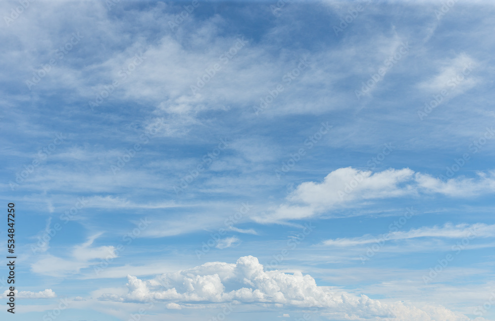 Sunny blue sky with clouds on partly cloudy day for background backdrop texture or sky replacement layer for composite art Sunny blue sky with clouds on partly cloudy day for background backdrop texture or sky replacement layer for composite art
