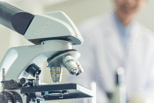 Science microscope equipment in biology chemical laboratory. Scientific experiment Microscope on Lab table microbiology equipment. Chemistry objects on lab background. Chemistry scientific concept