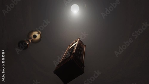 falling clock down the rabbit hole darkness lit by a vintage lamp, moving time. looping animation