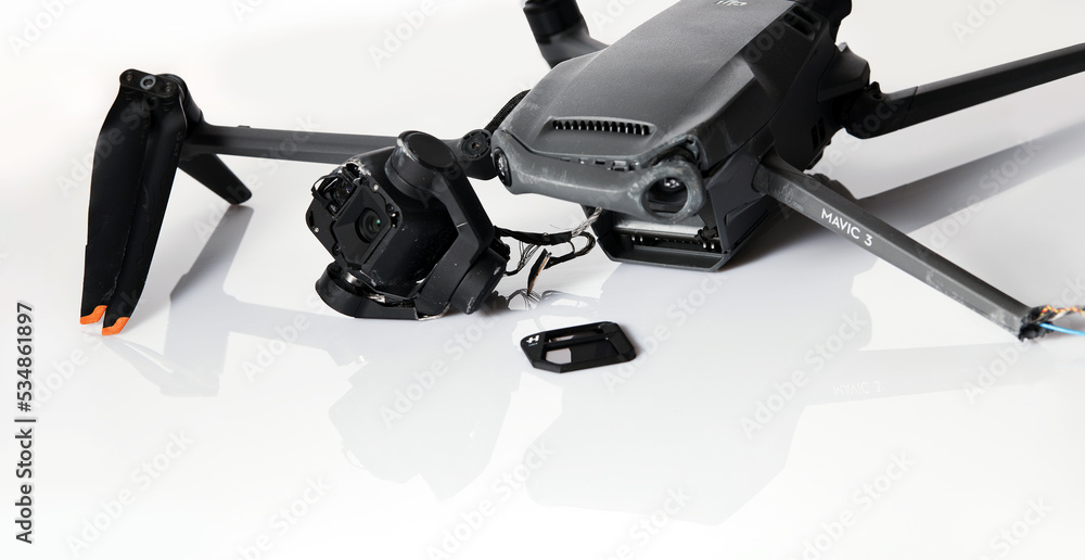 Drone DJI Mavic 3 after crashed on a white background. Drone after falling  from a height. Broken gimbal camera and drone motor arm after crash.  08.05,2022. Rostov region, Russia Photos | Adobe Stock