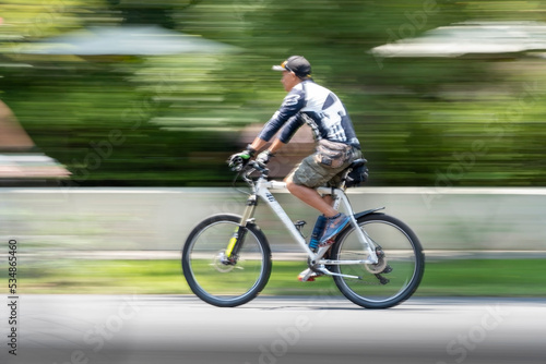 young man on bicycle, riding a sunday, photo with swept background and out of focus, mexico © rodrigo
