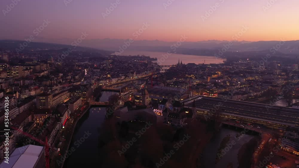 Zurich, Switzerland: Aerial drone footage of the sunset over Zurich city center with the Limmat river that flows through the old town to join lake Zurich in Switzerland. Shot as a time lapse