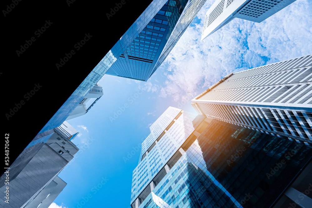 Office tall building. Low angle view of skyscrapers modern office building city in business center with blue sky