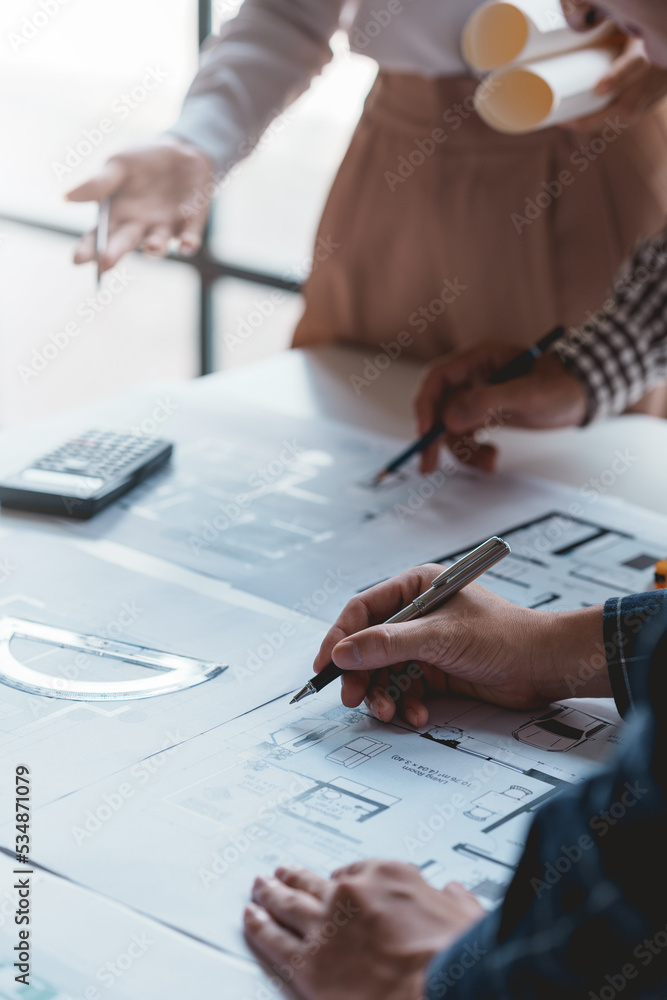 Architect or engineers are meeting to discuss home design. modify plans build a construction project and modify the work according to the needs of the customer. Architect or engineers are meeting to discuss home design. modify plans build a construction project and modify the work according to the needs of the customer.