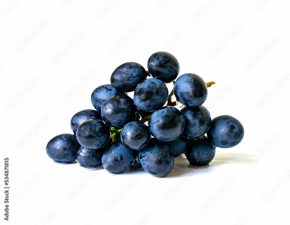 Black grapes candied fruit on a white background Black grapes candied fruit on a white background