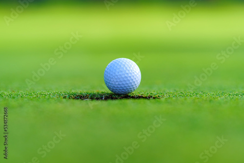Golfer putt golf ball into hole on the green at golf course