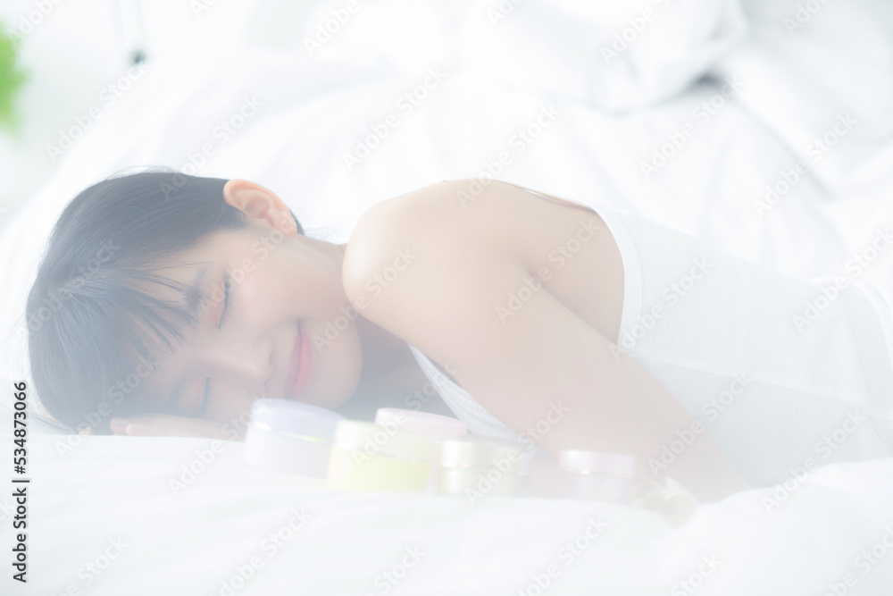 Beautiful of young asian woman smiling and lying on bed at bedroom, beauty of girl with hygiene and healthy, cream and lotion and skin care, cosmetic and makeup, skincare and lifestyles concepts. Beautiful of young asian woman smiling and lying on bed at bedroom, beauty of girl with hygiene and healthy, cream and lotion and skin care, cosmetic and makeup, skincare and lifestyles concepts.