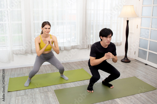 Young woman and man practicing workout stretching squat for muscle leg and hands while motivation and determined  exercise and sport  two people  recreation with workout for health care concept.