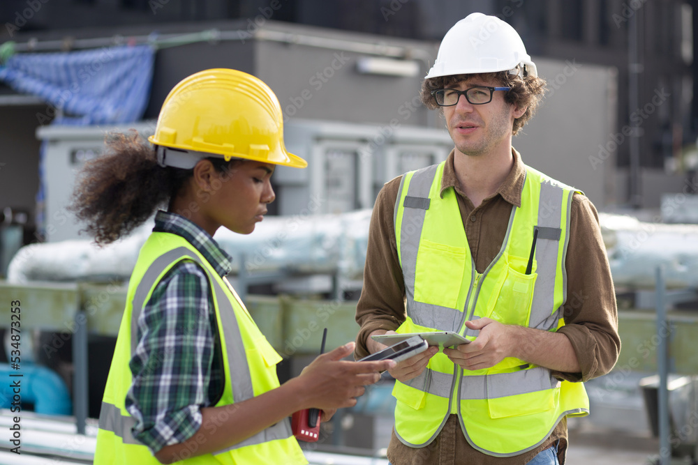Young man and woman is architect planning and inspector project and looking digital tablet at construction site, engineer male and female working and examining for development real estate. Young man and woman is architect planning and inspector project and looking digital tablet at construction site, engineer male and female working and examining for development real estate.