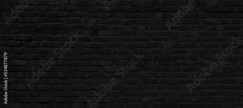 Texture of old black brick wall large background.