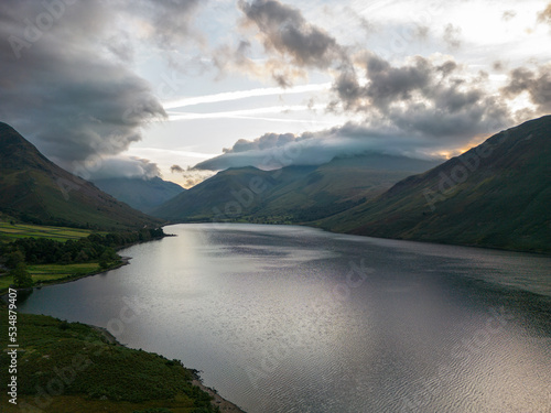 The sun lights up trees on the shore of Wastwater in the lake district
