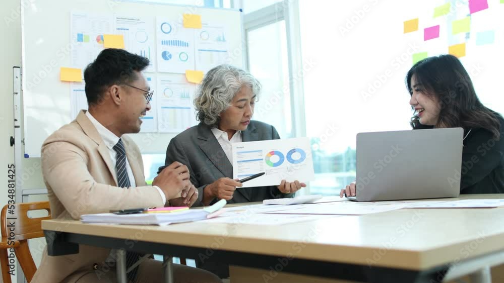 Asian business people meeting team working with accounting documents and laptop at the table in office, Happy team working and business training to technology concept, financial planning meeting. Asian business people meeting team working with accounting documents and laptop at the table in office, Happy team working and business training to technology concept, financial planning meeting.