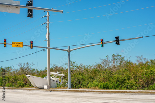 Boat laying at an intersection after being blown away by Hurricane Ian strong catagory 4 winds photo